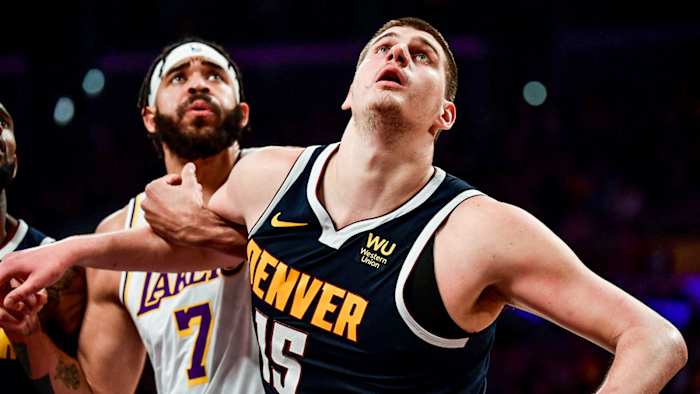 Nikola Jokic battles JaVale McGee for rebound.